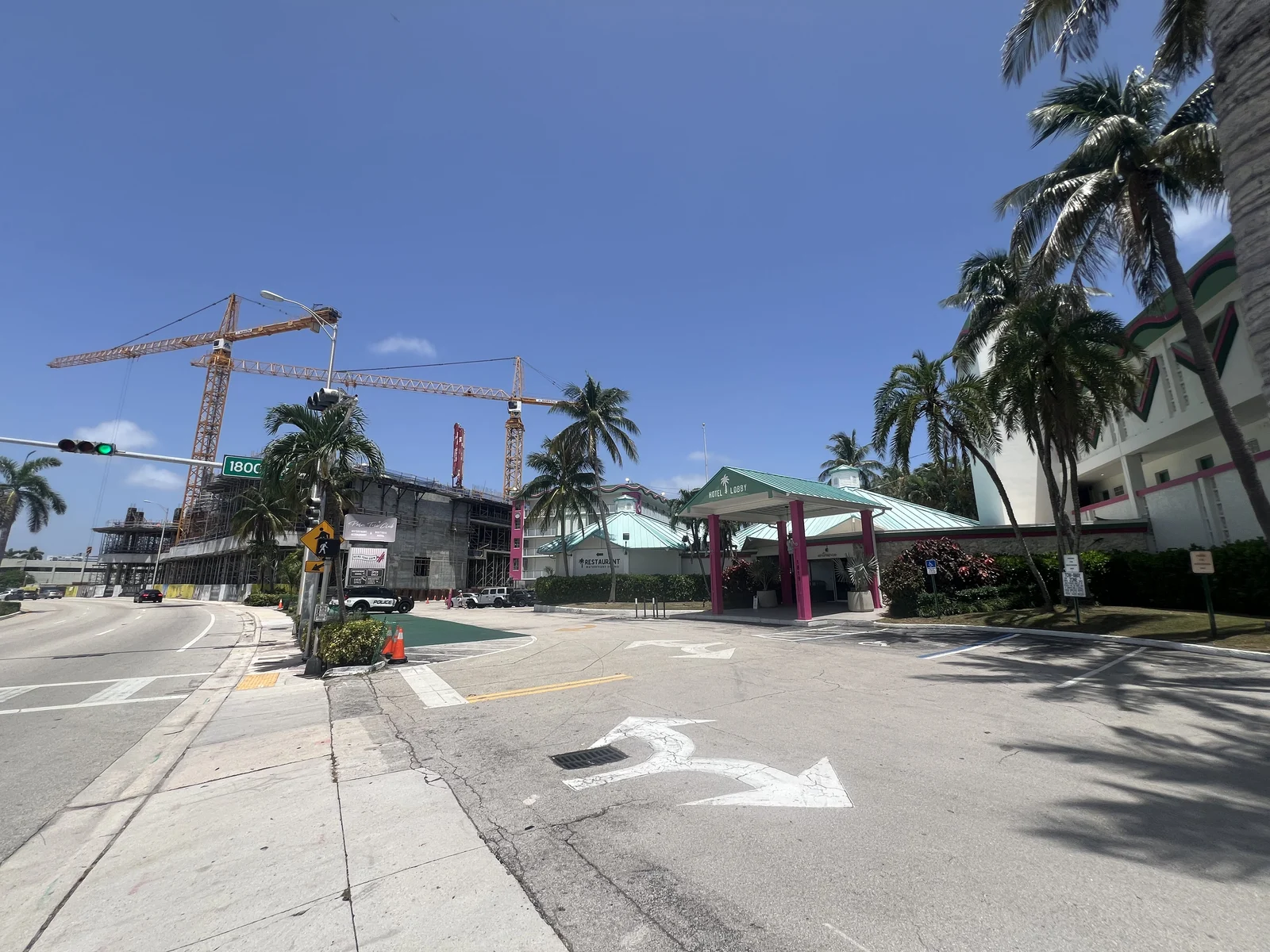 Continuum construction and cranes to the left of Palm Tree Club’s hotel entrance