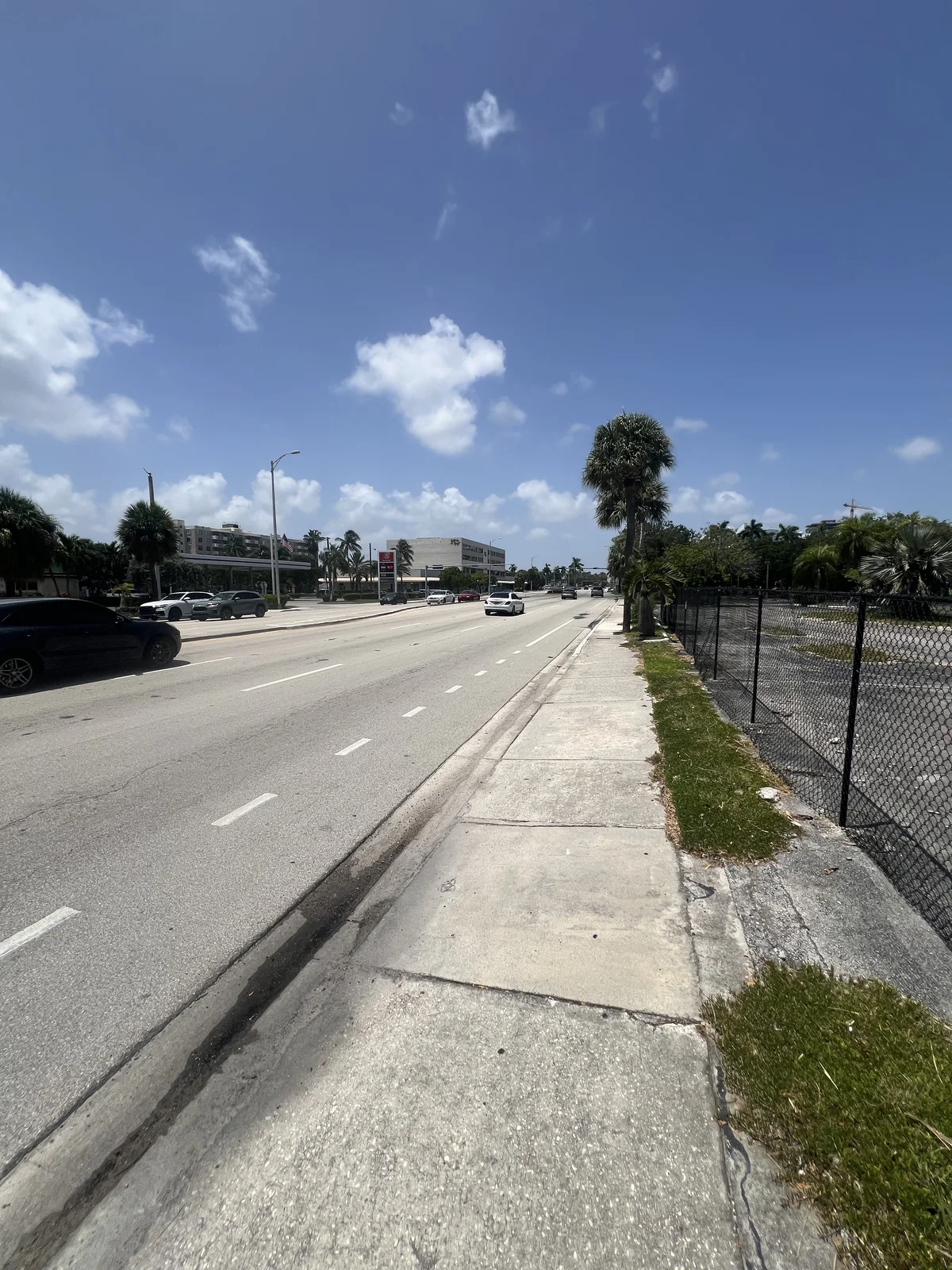 Fenced lots along the north side of the causeway, photographed August 15, 2026