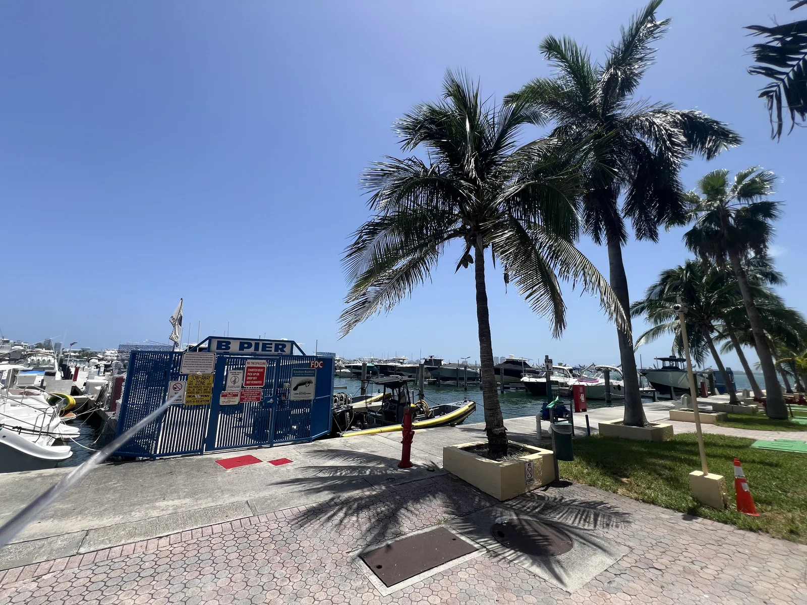 The signed B Pier entrance and boats beyond the gate