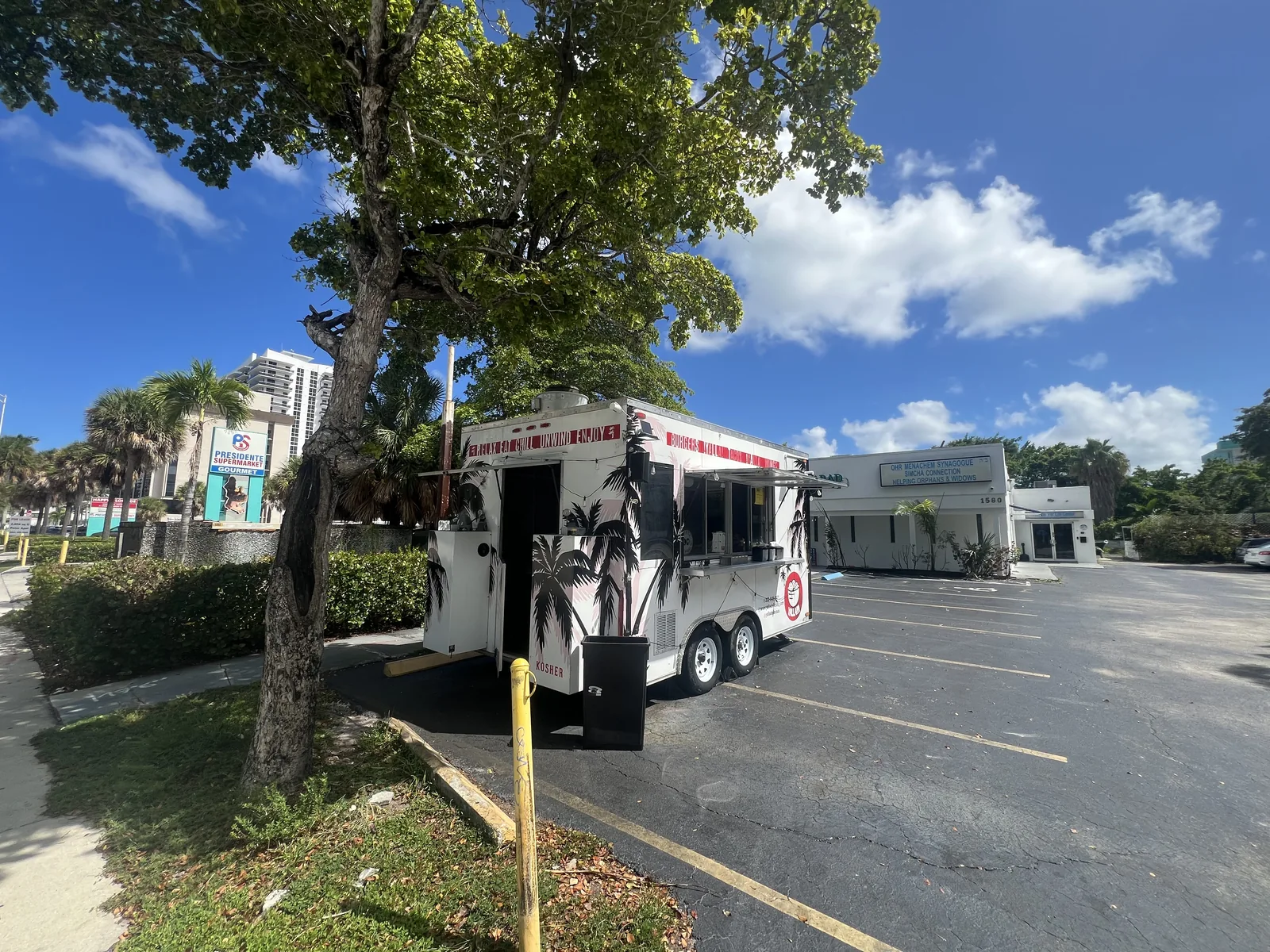 A first glimpse of Yalla Delicious beside the trees on Treasure Island.