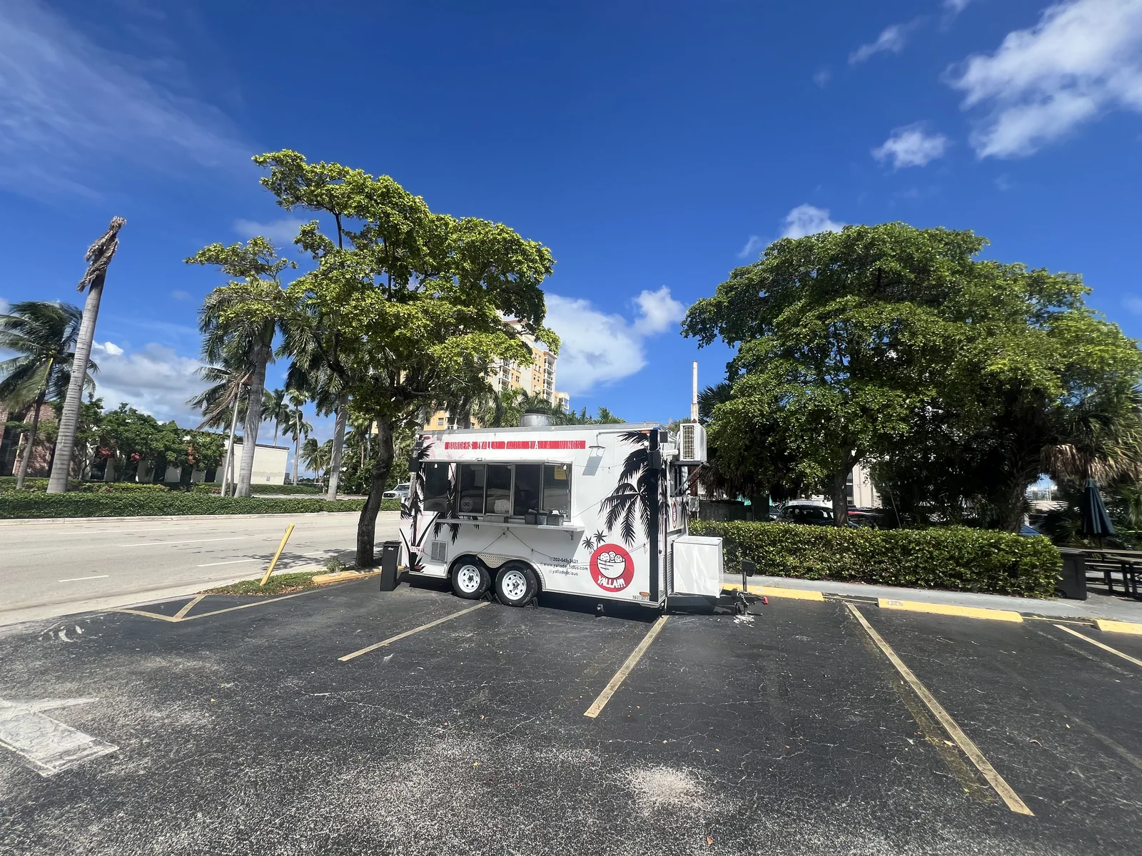 The wider parking-area view puts the food truck in its neighborhood setting.